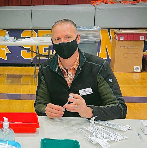 Pharmacist Eric Beyer prepares for a COVID-19 vaccination clinic for teachers at Sentinel High School in Missoula, Montana.
