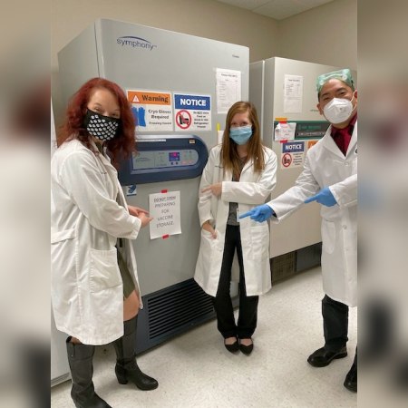 Jennifer Courtney, PharmD (left), and colleagues show off the ultra-cold freezer for storing CNU College of Pharmacy's first shipment of COVID-19 vaccines.