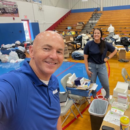 Joel Thornbury, RPh, with then student pharmacist Kristen Coleman, now PharmD, at a vaccine clinic at Duff-Allen Central Elementary School in Eastern, Kentucky, held in the wake of massive floods in the region during 2022. The gymnasium served as a clinic for vaccinations and basic medical care and a distribution center for food and clothing.