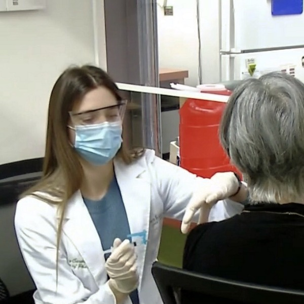 Liz Carmosino, PharmD, vaccinates a patient at Balls Foods Hen House Market Pharmacy in Kansas City, Kansas.