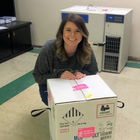 Pharmacist Allie Staton with a shipment of COVID-19 vaccines.