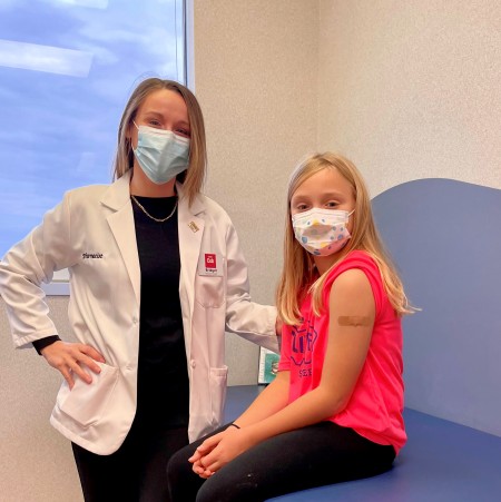 Pharmacist Bridget Ogden with her daughter after administering a COVID-19 vaccine at a pediatric practice in Burnsville, Minnesota.