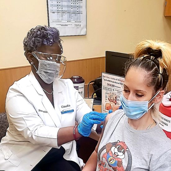 Pharmacist Claudia Taylor vaccinates a patient at the Cypress Station Kroger Pharmacy in Houston, Texas.