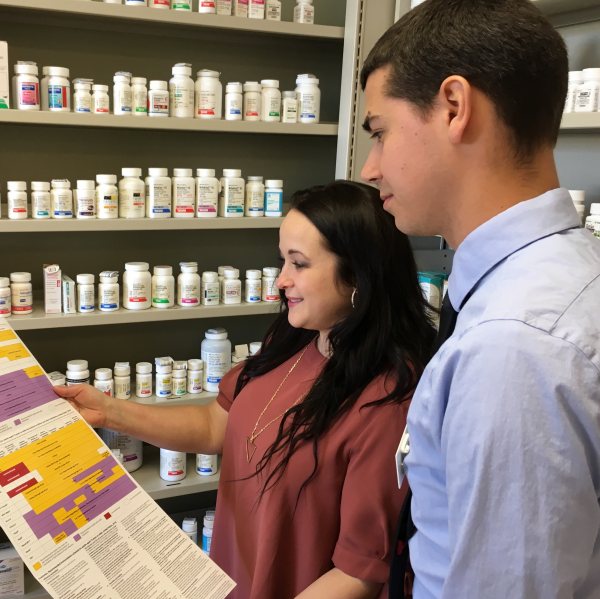 Pharmacist Elizabeth Skoy (left) discusses the CDC immunization schedules with a pharmacy intern at North Dakota State University’s concept pharmacy.