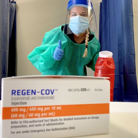 Pharmacist Erica Mabry dons a face shield, mask, gloves, and gown to administer monoclonal antibody therapy to COVID-19–positive patients at Eden Drug in Eden, North Carolina.