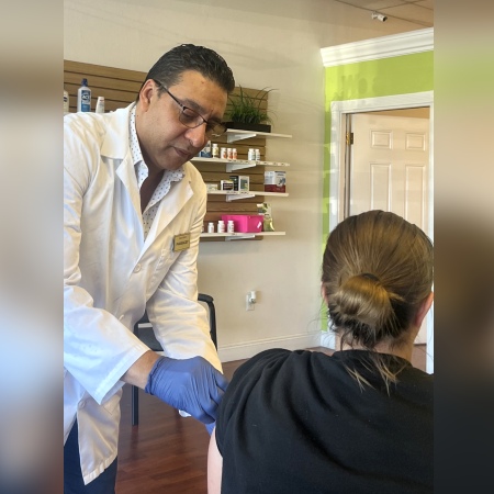 Pharmacist Hany Gerges administers a COVID-19 vaccine to a patient at Care Plus Pharmacy in Palm Harbor, Florida.