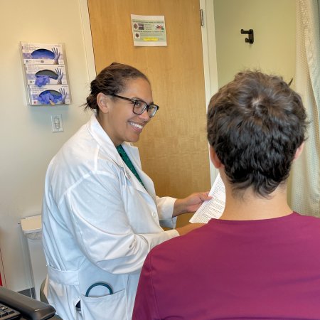 Pharmacist Jerica Singleton reviews vaccine information with a patient in the ambulatory clinic at USF Health in Tampa, Florida.