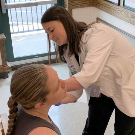 Pharmacist Karen Taubenslag administers a COVID-19 vaccine to a patient at the Harris Teeter Pharmacy in Alexandria, Virginia.