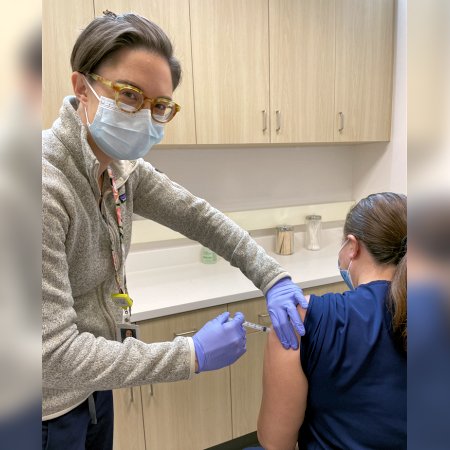 Pharmacist Keri Hurley-Kim vaccinates a patient at Saban Community Clinic in Los Angeles, California.