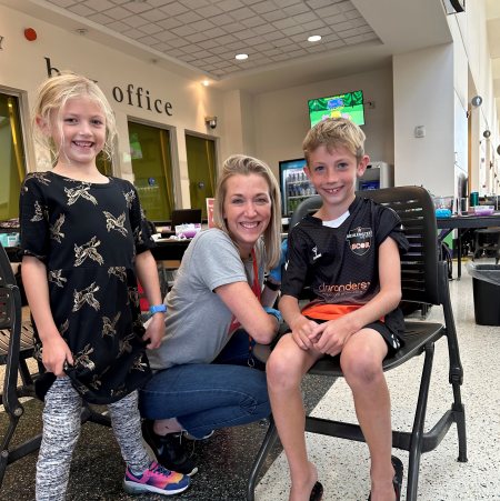 Pharmacist Lisa Bade with her children at ArtPrize 2022 in Grand Rapids, Michigan, where Bade and pharmacy colleagues vaccinated community members at the Immunize at ArtPrize pop-up clinic. .