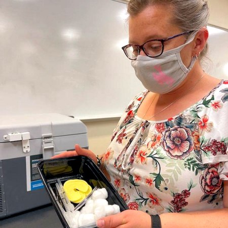 Pharmacist Melissa L. Hunter displays the vaccine administration kits used for the COVID-19 vaccine clinic during Freshmen Move-In Day at the University of Wyoming.