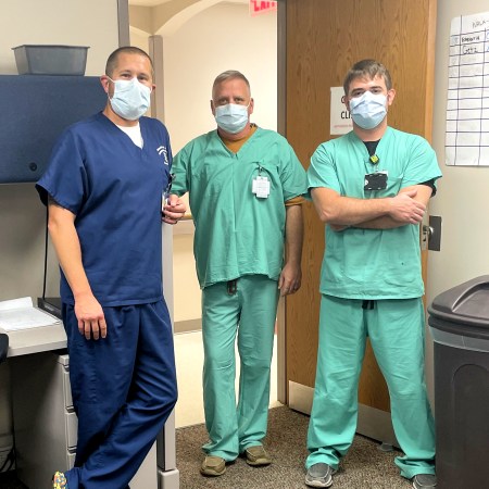 Pharmacist Nick Patterson (left) with physician assistants Paul Strohl (middle) and Nicholas Basham (right) during a COVID-19 vaccination clinic at Blanchfield Army Community Hospital in Fort Campbell, Kentucky.