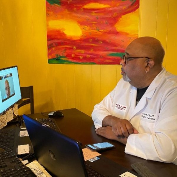 Pharmacist Rick Peters participates in a video conference call discussing COVID-19 and the vaccines.