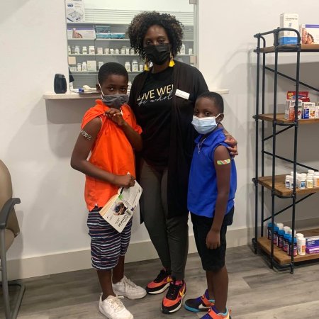 Pharmacist Shadreka McIntosh after administering a first dose of Pfizer COVID-19 vaccine to her 7-year-old son and his 9-year-old friend at Sozo Wellness Pharmacy’s pediatric vaccine event.