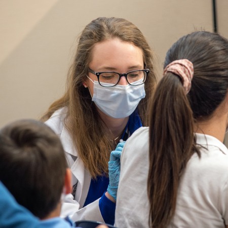 Pharmacist Sophia Herbert vaccinates a pediatric patient at the Pitt Vaccination and Health Connection Hub in Pittsburgh, Pennsylvania.