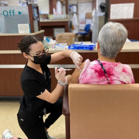 Student pharmacist Anna Lopez Concepcion vaccinates a patient against COVID-19 at Randalls Pharmacy in Houston, Texas.