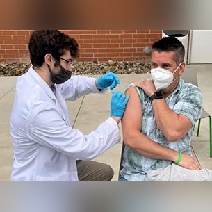 Student pharmacist Brandon Keaton administers a COVID-19 vaccine at Marshall University School of Pharmacy in Huntington, West Virginia.