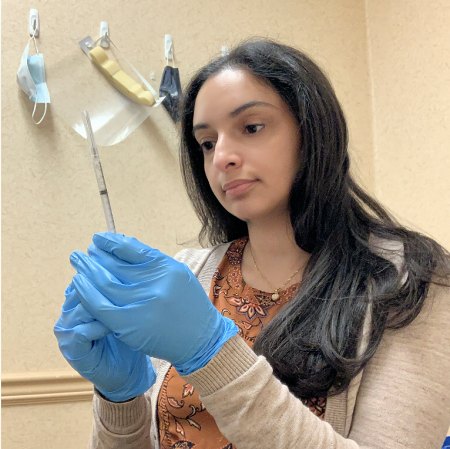 Student pharmacist Elaine Marji, CPhT, prepares a COVID-19 vaccine for administration at a Walgreens in Buffalo, New York.
