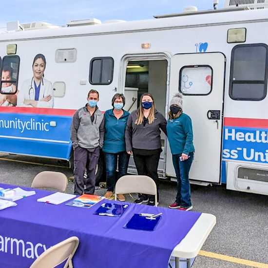 Victoria Hennessey, PharmD (second from right) pictured with pharmacy technicians prepare for the pharmacy’s mobile clinic in Springdale, Arkansas.