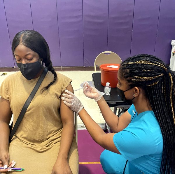Vondalyn Wright, PharmD, vaccinates a patient at a local community event in Tampa, Florida.