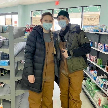 As fourth-year student pharmacists, Cate Halloran (left) and Evan Stoll (right) vaccinated more than 100 patients against COVID-19, in the parking lot of Community Pharmacy in Springdale, Arkansas, after a snowstorm in February 2021.