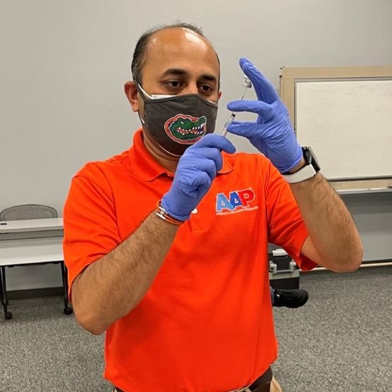 Ritesh Patel, PharmD, prepares vaccines before a clinic at Raleigh Charter High School in Raleigh, North Carolina.